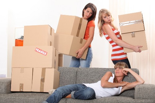 Local movers handling furniture in a Hackney street